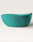 Front view of the Bellastone Soma freestanding bath in celadon blue with a black magnetic pillow