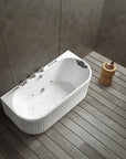 A top view of the Bellastone Doria back-to-wall with faucet bathtub in white with silver tap ware, in a modern bathroom with wooden floor and gray walls.