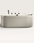 Front view of the Bellastone DORIA Spa Bath in cream with black tap ware