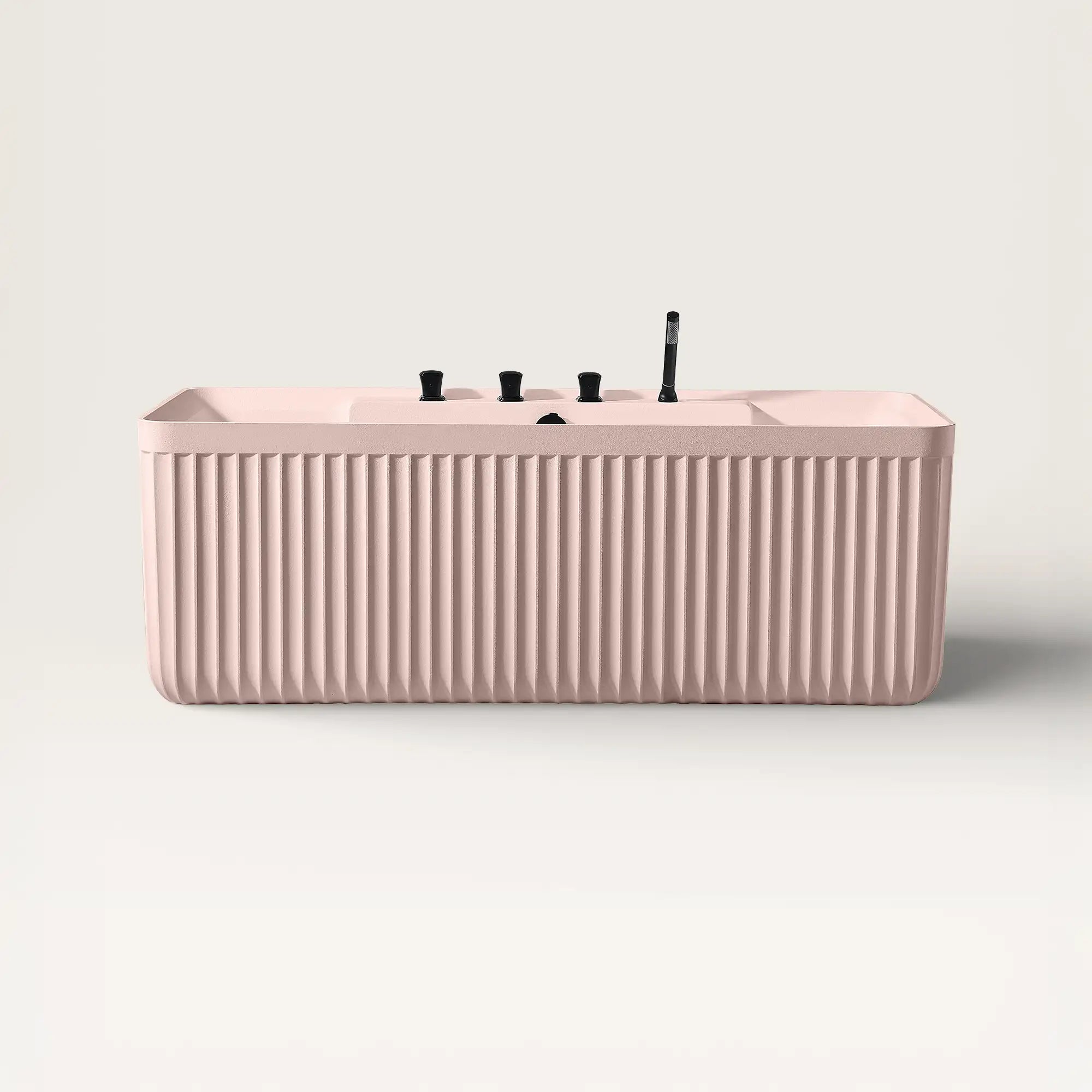 Front view of the Bellastone Kolpa back-to wall bath with black tap ware in pink