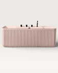 Front view of the Bellastone Kolpa back-to wall bath with black tap ware in pink