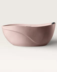 Front view of the Bellastone Soma freestanding bath in pink with a black magnetic pillow