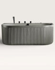 Front view of the Bellastone DORIA Spa Bath in cement-grey with black tap ware