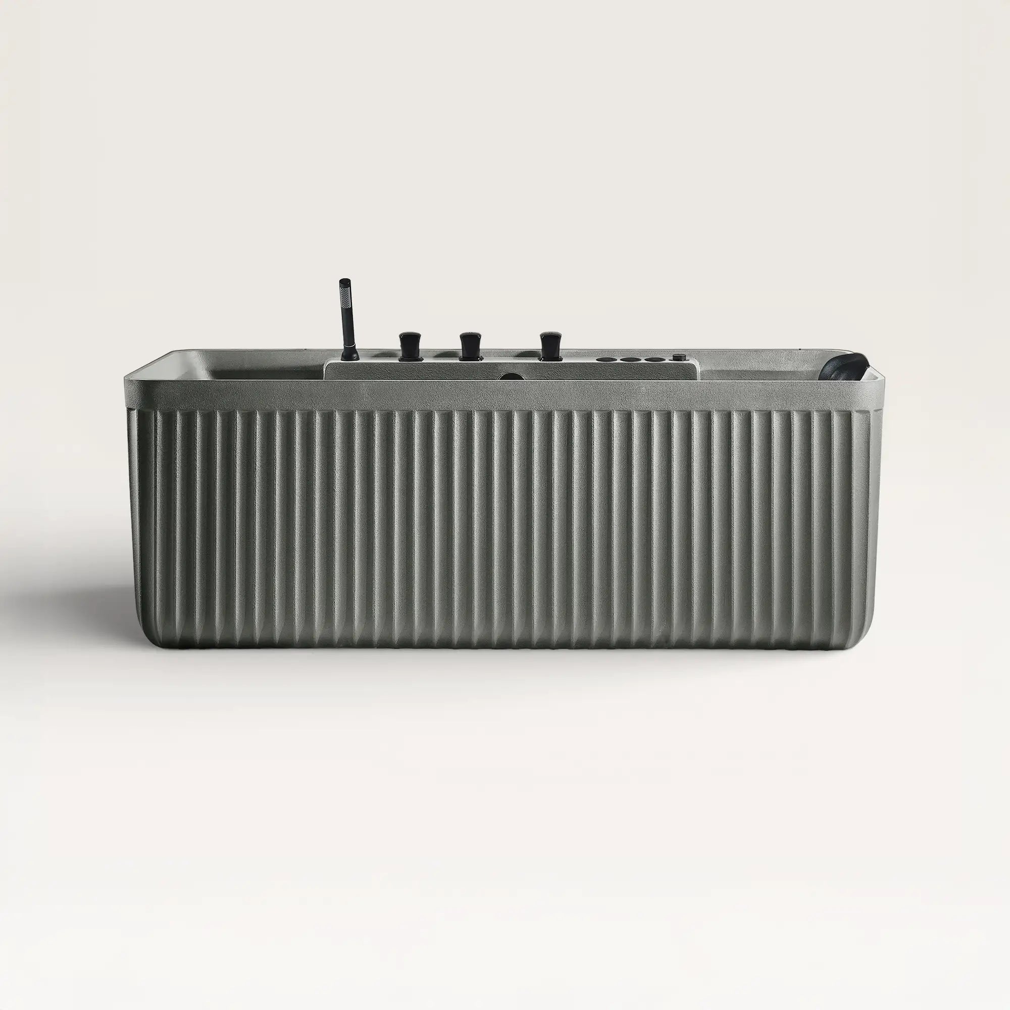 Front view of the Bellastone Kolpa Spa bath with black tap ware in cement-grey