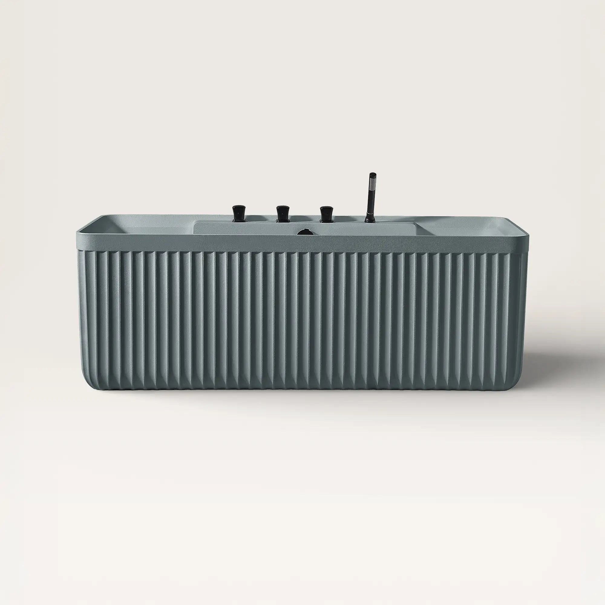 Front view of the Bellastone Kolpa back-to wall bath with black tap ware in blue-grey