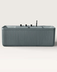 Front view of the Bellastone Kolpa back-to wall bath with black tap ware in blue-grey