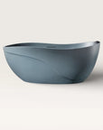 Front view of the Bellastone Soma freestanding bath in blue-grey with a black magnetic pillow