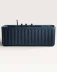Front view of the Bellastone Kolpa Spa bath with black tap ware in prussian blue