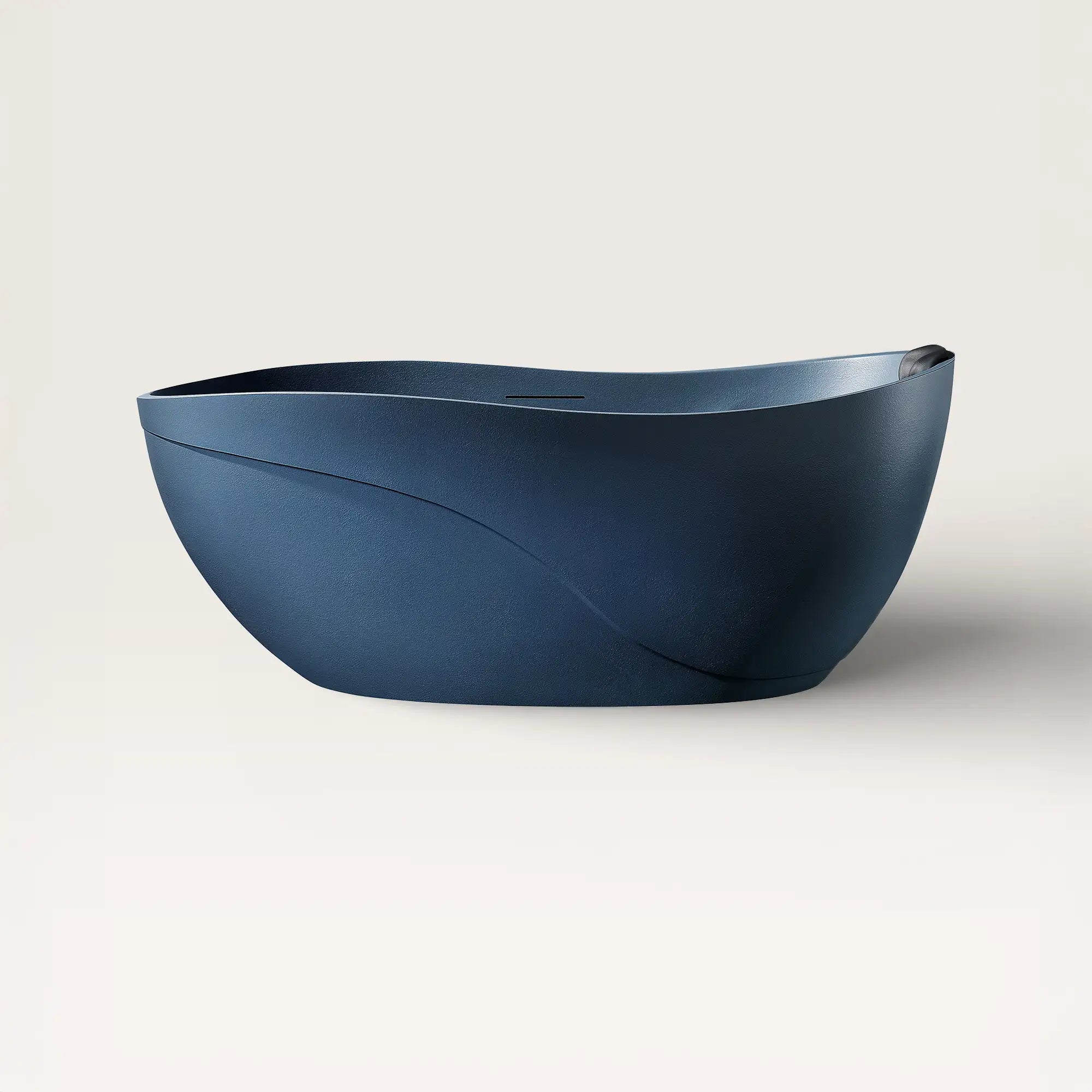 Front view of the Bellastone Soma freestanding bath in prussian blue with a black magnetic pillow