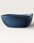 Front view of the Bellastone Soma freestanding bath in prussian blue with a black magnetic pillow