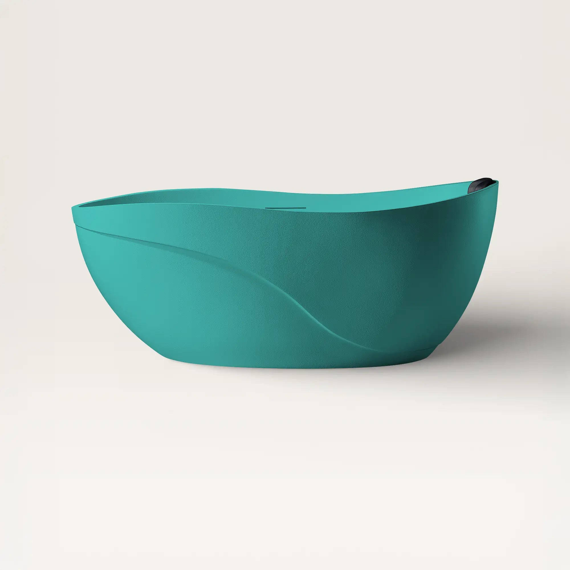 Front view of the Bellastone Soma freestanding bath in celadon blue with a black magnetic pillow