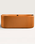 Front view of the Bellastone DORIA Back-to-wall Bath in orange
