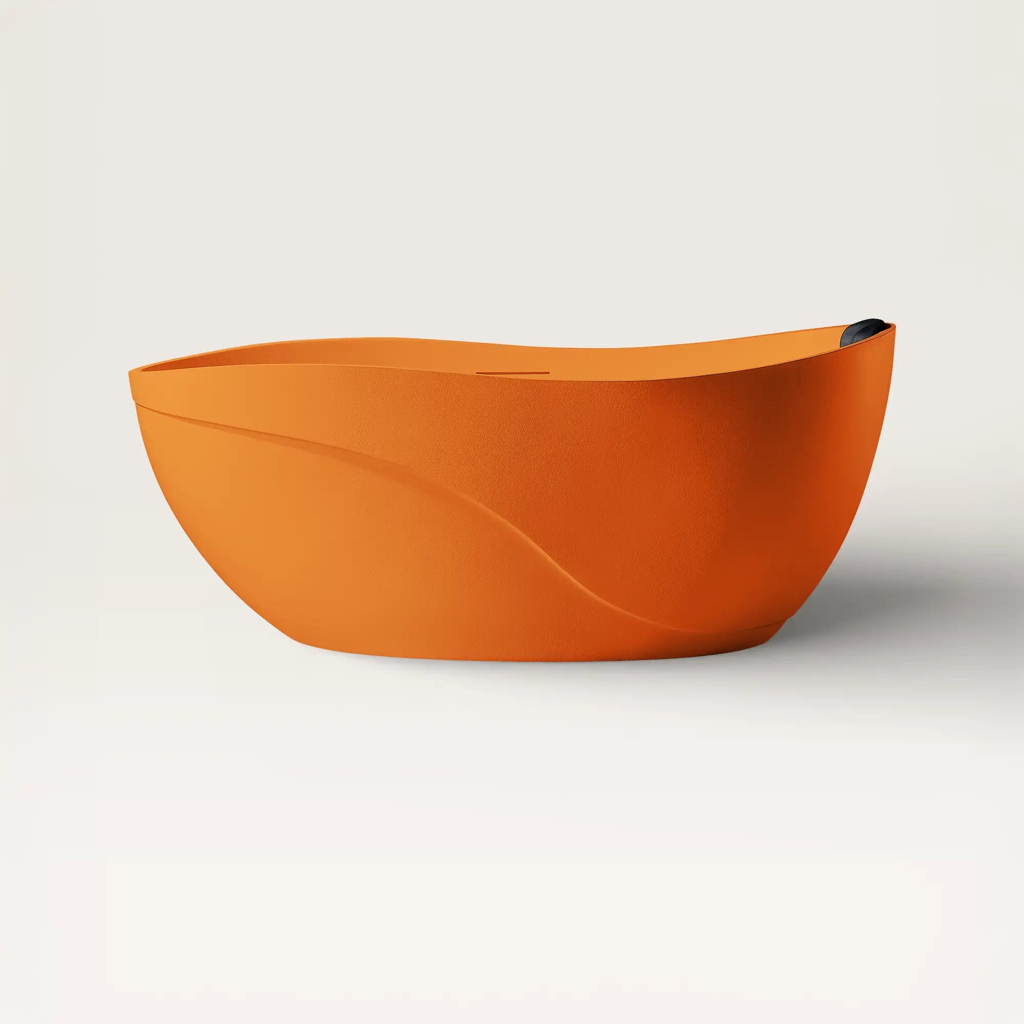 Front view of the Bellastone Soma freestanding bath in orange with a black magnetic pillow